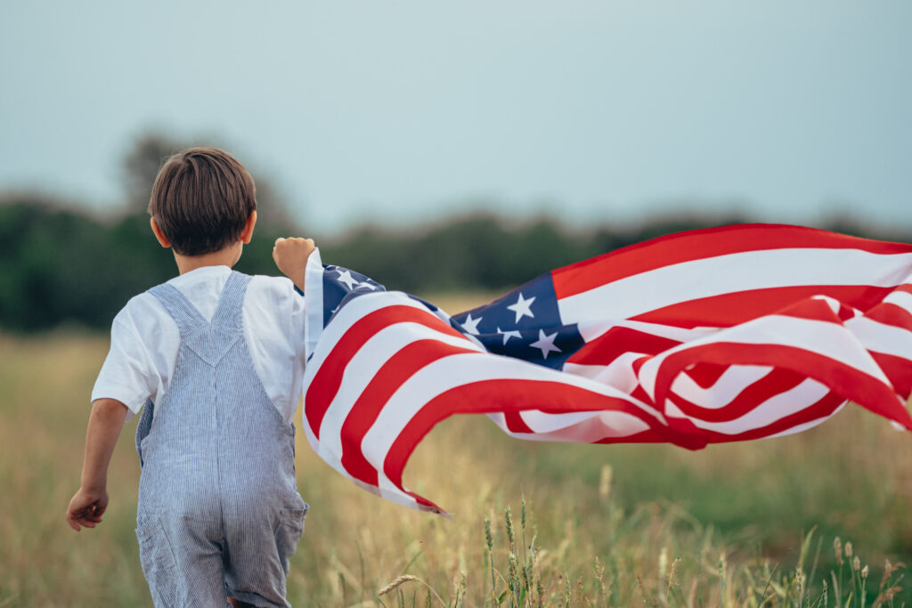 Trump Account for Child in 2026 - Little boy running with American Flag